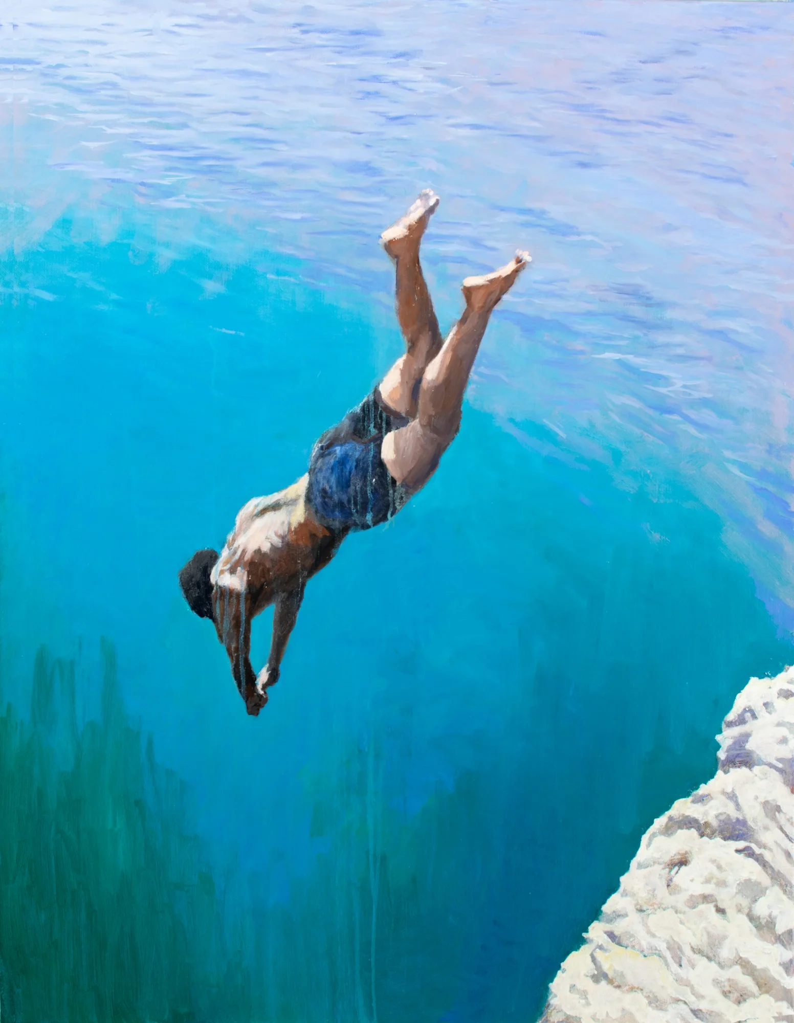 Figure diving from a cliff captured in mid-action above the sea