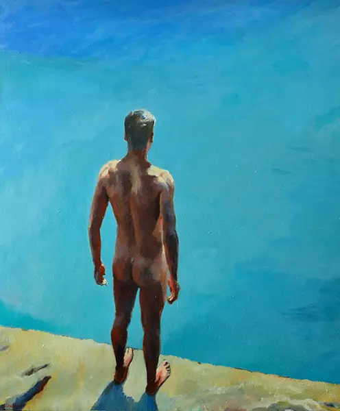 Male figure standing at the edge of an electric blue sea